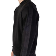Black crewneck sweater by Armani Exchange featuring a ribbed neck and dark gray vertical stripe with brand lettering