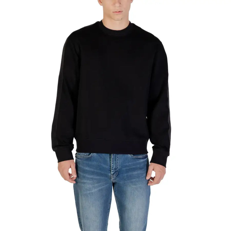 Black crewneck sweater with ribbed cuffs and hem made from soft fabric for casual and comfortable wear