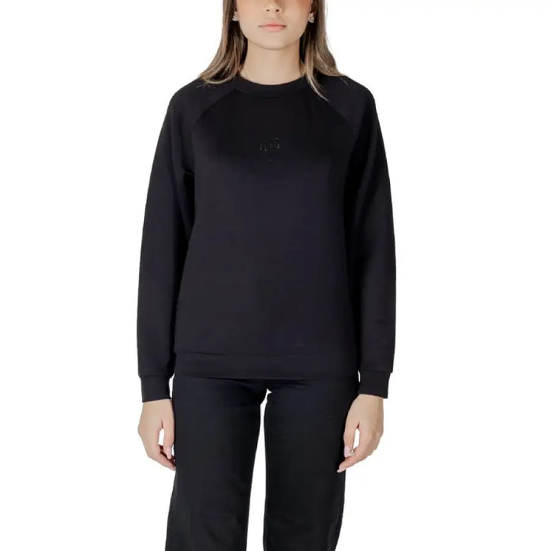 Women’s light blue sweatshirt and black pants set displayed for casual wear