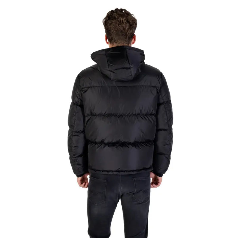 Black hooded puffer jacket with quilted design and hood made from insulated material for cold weather use