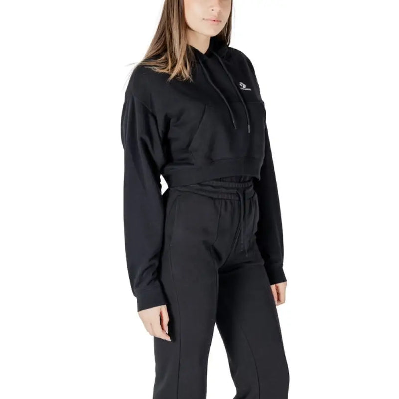 Black Converse cropped hoodie and pants set displayed on a retail mannequin