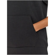 Hand in pocket of Under Armour Women’s Black Hooded Sweatshirt with Pockets