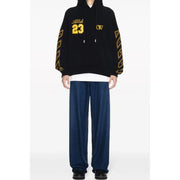 Black hoodie with yellow accents featuring gold abloh 23 lettering and geometric patterns along the sleeves