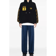 Black hoodie with yellow accents featuring gold abloh 23 lettering and geometric patterns along the sleeves