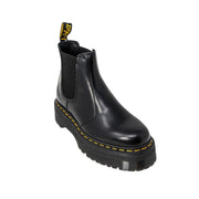 Black leather platform chelsea boot with yellow stitching and a thick sole for stylish durable wear