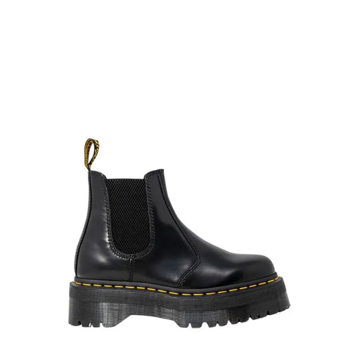 Black leather platform chelsea boot showing the back side with smooth polished finish and sturdy sole