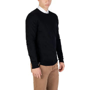 Black crew neck sweater with white collar and cuffs, made of cotton.