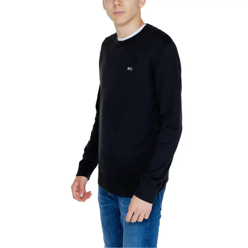 Black long-sleeved crewneck sweater displayed for stylish casual wear