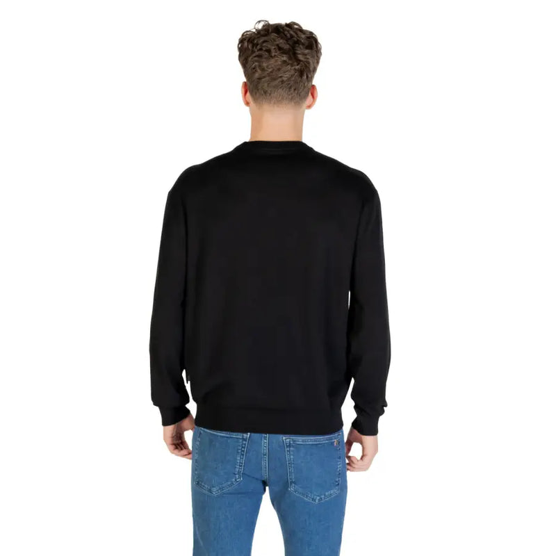 Black long-sleeved crewneck sweater displayed in a product image with a clean background