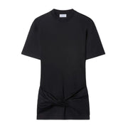 Black short-sleeved t-shirt with knotted hem detail styled with black mini dress and sculptural heels