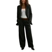 Black pinstripe blazer with lapel collar and pockets paired with matching wide-leg trousers set