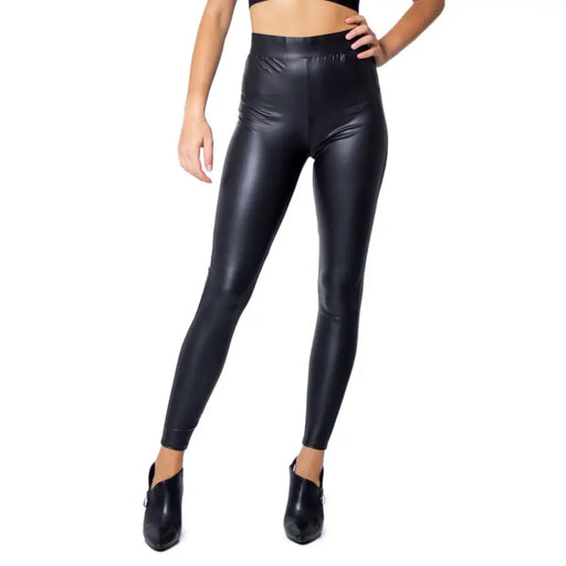 Black polyester elastane women leggings with a shiny faux-leather finish high waisted for fall and winter wear