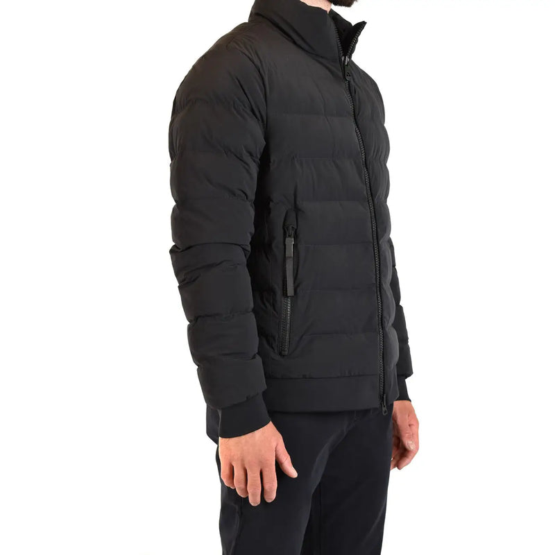 Black quilted puffer jacket with high collar and zippered pockets for warmth and style