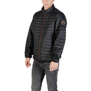 Black quilted puffer jacket with brown zipper and circular logo patch on the sleeve in insulated material