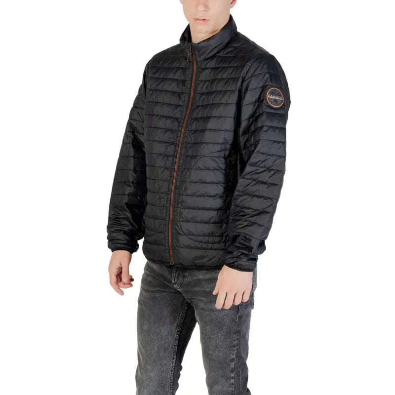 Black quilted puffer jacket with brown zipper and circular logo patch on the sleeve in insulated material