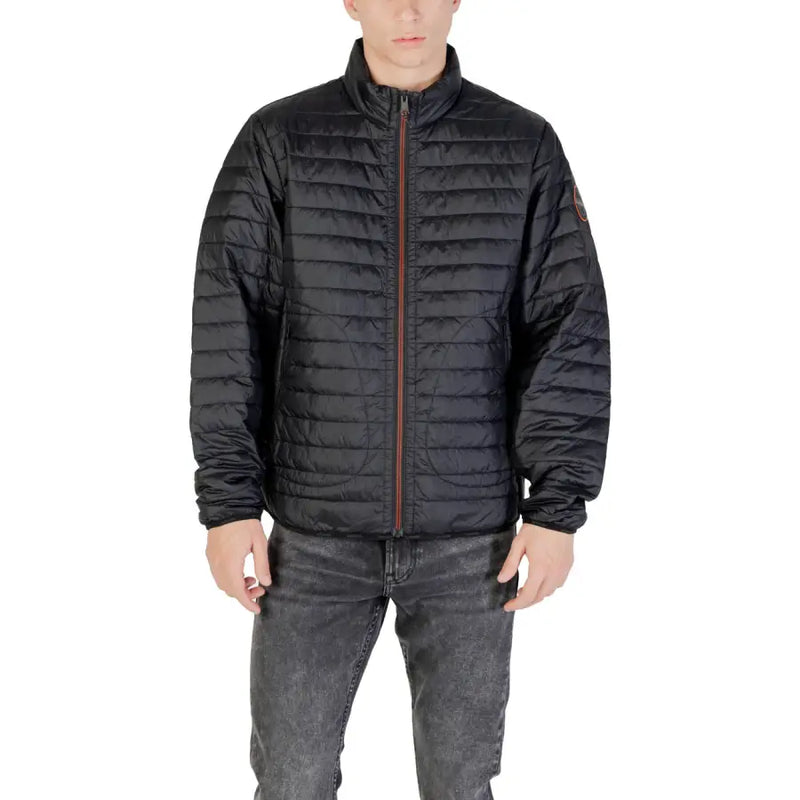 Black quilted puffer jacket with brown zipper and subtle logo patch on sleeve in warm insulated material