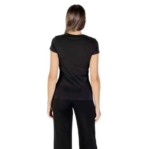 Black short-sleeve crewneck cotton T-shirt with rhinestones paired with matching wide-leg pants