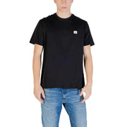 Black short sleeve crewneck t-shirt made of soft cotton with a small white Calvin Klein logo patch on the left chest