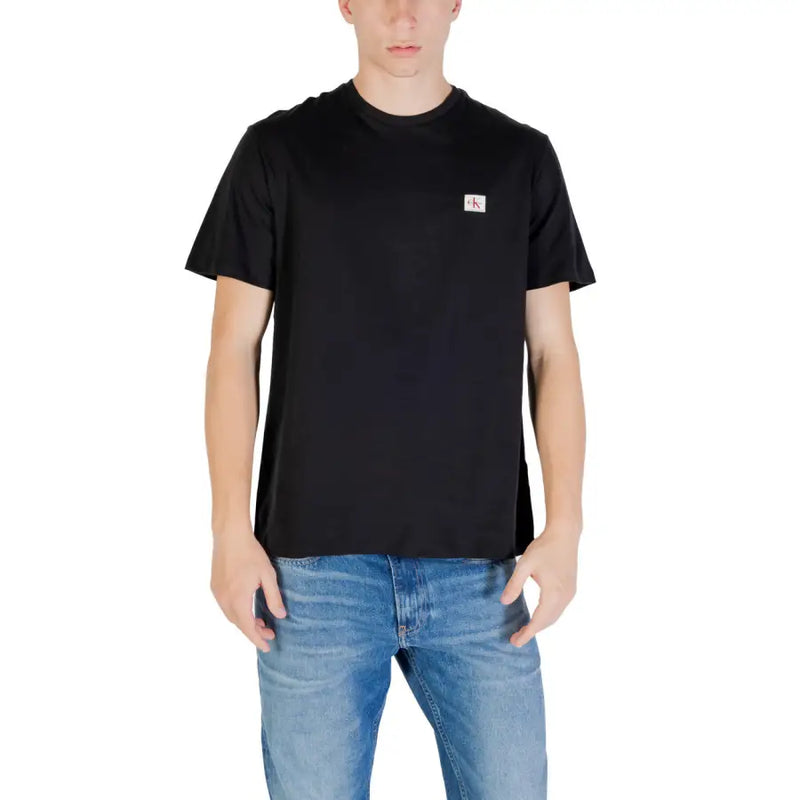 Black short sleeve crewneck t-shirt made of soft cotton with a small white Calvin Klein logo patch on the left chest