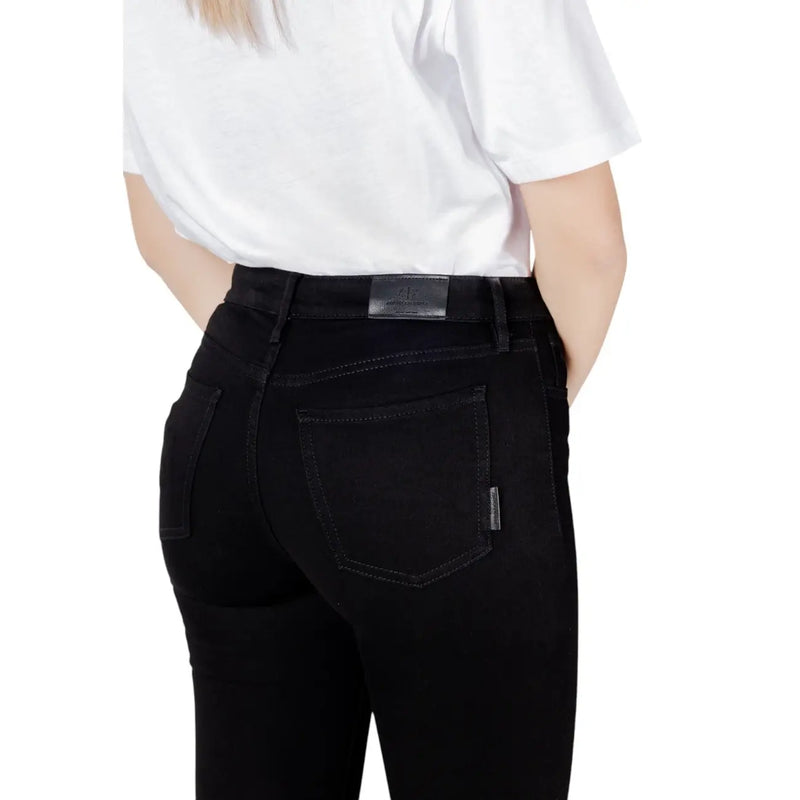 Black skinny jeans featuring a sleek slim-fit cut with subtle stitching details in high-quality denim material