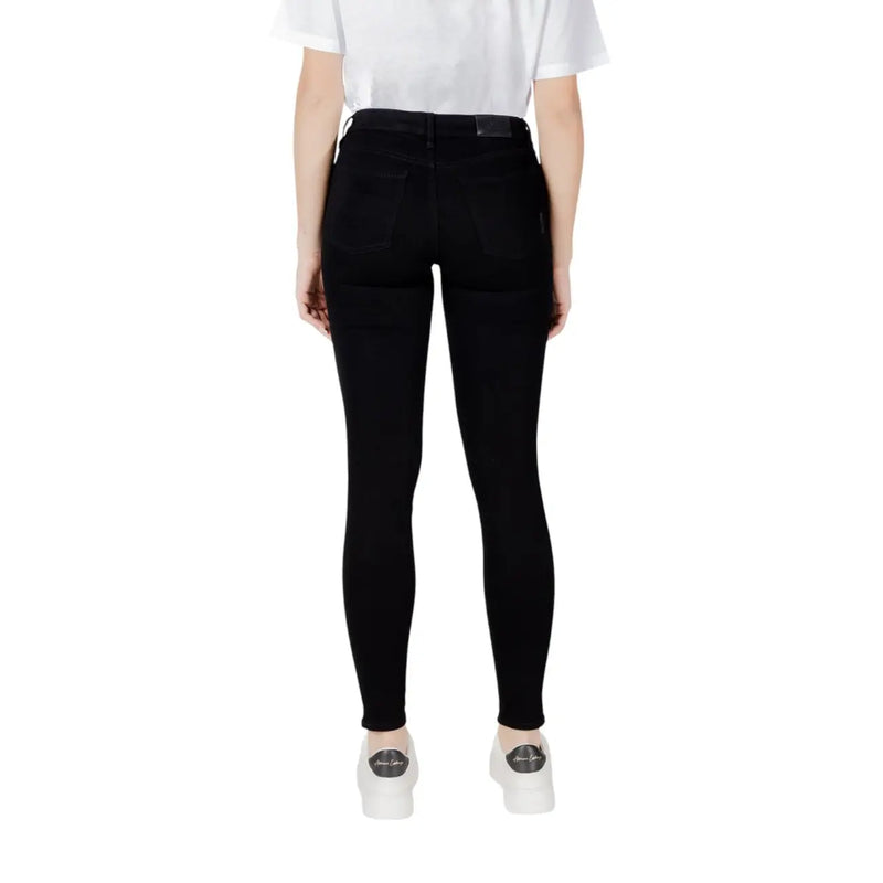 Black skinny jeans featuring a sleek, form-fitting design and high-waisted fit in a solid black color