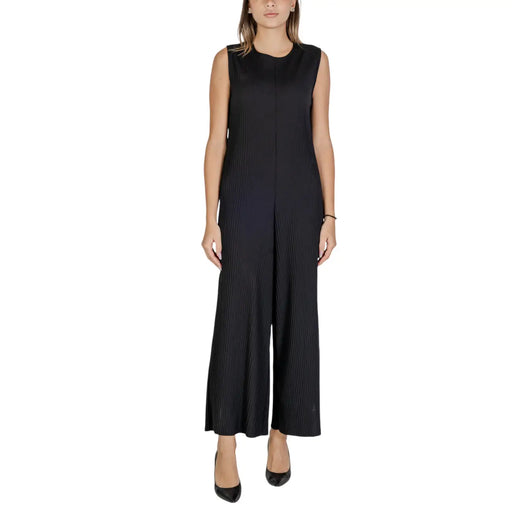 Black sleeveless polyester jumpsuit with pleated bodice wide-leg pants and front zipper closure