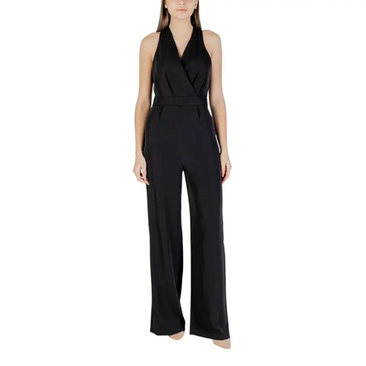 Black sleeveless wide leg halter jumpsuit in black satin with belted waist and wide leg pants