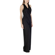 Black sleeveless wide-leg halter jumpsuit displayed on a mannequin in a fashion store