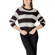Black and white horizontally striped acrylic knit sweater with round neck and slightly cropped textured silhouette