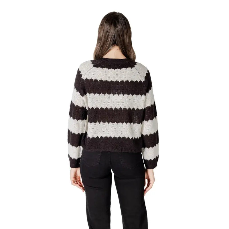 A cozy black striped long sleeve round neck acrylic sweater with bold black and cream horizontal knit stripes