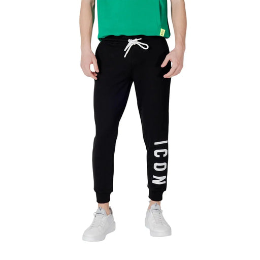 Black sweatpants with white drawstring featuring vertical icon lettering on the left leg made from soft fabric