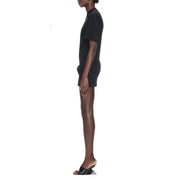 Black t-shirt dress with sculptural heels and knotted detail displayed in product image