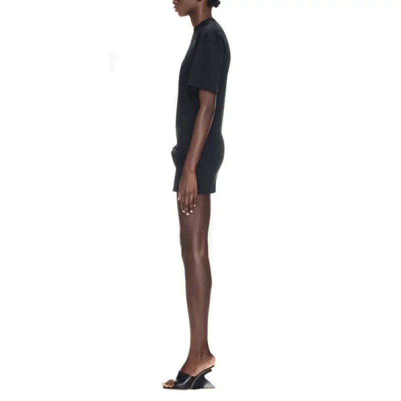 Black t-shirt dress with sculptural heels and knotted detail displayed in product image