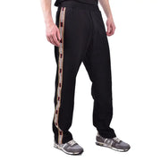 Black track pants with side stripes displayed on a model for athletic or casual wear