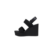 Elegant black wedge sandal displayed in the product image for stylish footwear selection