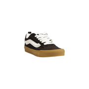 Black and white Vans sneaker with gum sole from Vans Men’s Brown Leather Sneakers collection