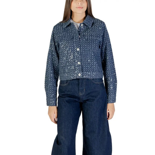 Women wearing a sequined denim jacket and wide-leg jeans in a fashion photoshoot