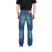 Blue denim jeans back side with faded wash, white stitching on pockets, and orange leather brand patch at waistband