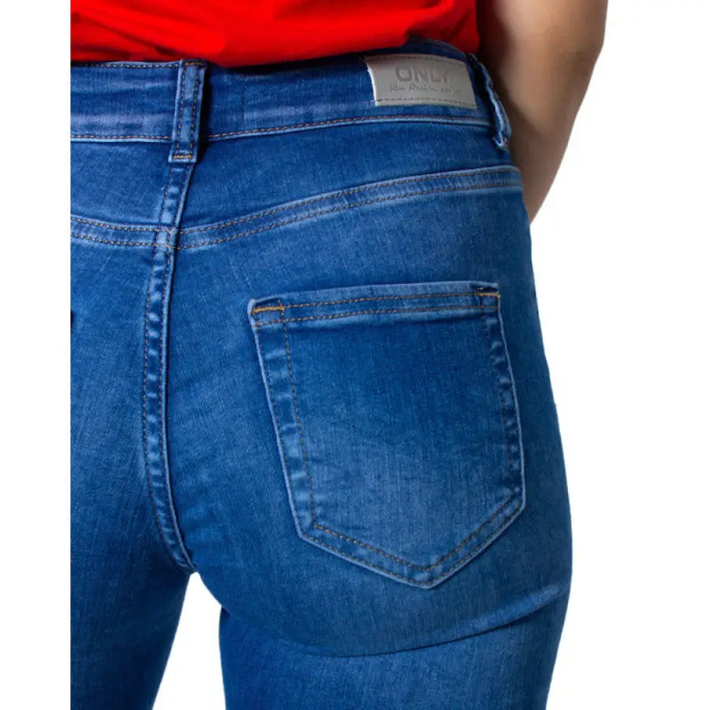 Blue denim skinny jeans displayed in a stylish fashion on a retail website