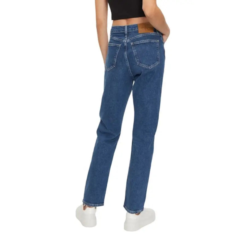 Blue denim jeans displayed with a women’s black crop top in a fashion product image