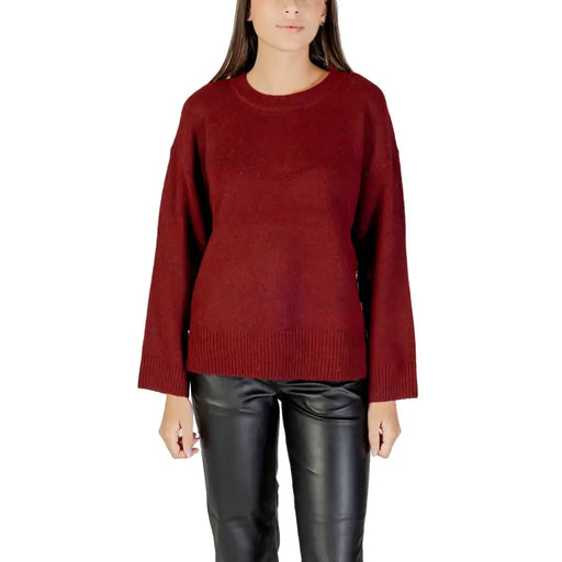 Women wearing Bordeaux round neck long knitwear with black leather pants for fall winter style