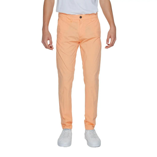 A pair of borghese men trousers in peach slim-fit chinos with subtle texture and a single button closure