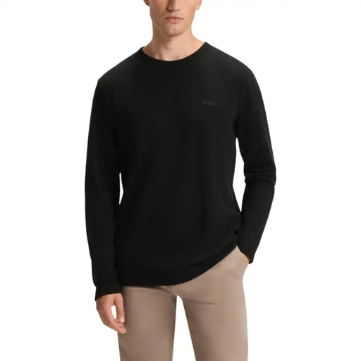 Black crew neck sweater with ribbed cuffs and hem, made of cotton.