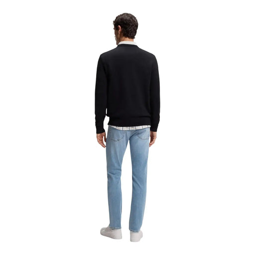 Boss cashmere sweater Kanovano for men in black worn over white collared shirt with light blue jeans front view