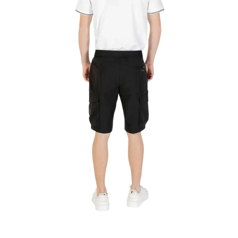 Black cargo shorts with multiple pockets and white sneakers.