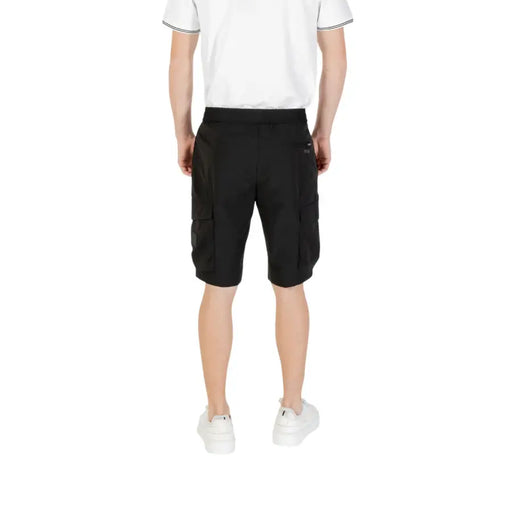 Black cargo shorts with multiple pockets and white sneakers.