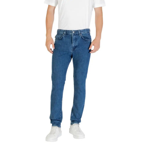 Blue denim jeans with a slim fit and white stitching, likely from levi’s 512 model.