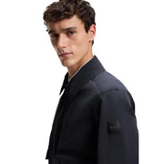 Dark navy blue boss men blazer classic fit polyester jacket with subtle texture and black embroidered logo patch on sleeve