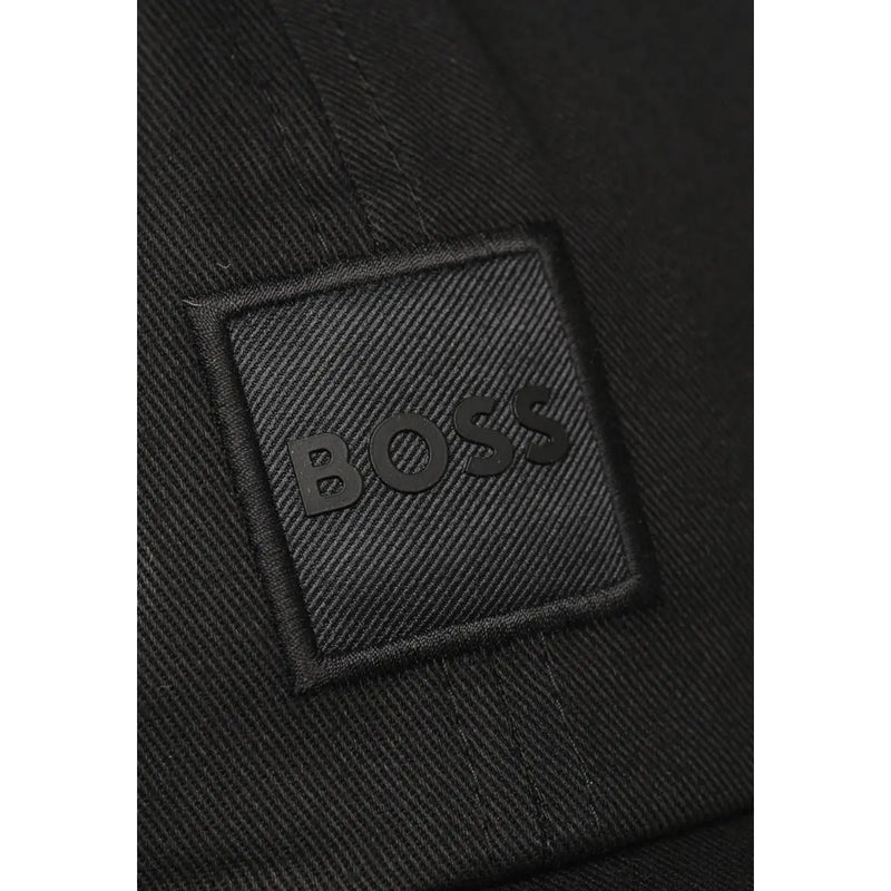 Black textured fabric patch with embossed boss logo stitched on dark woven material of boss men cap 100% cotton