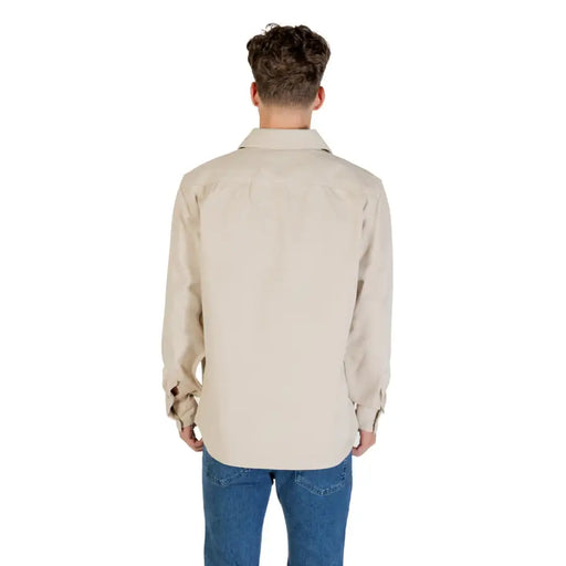 Boss Men Classic Beige Long Sleeve Round Neck Shirt worn over blue jeans